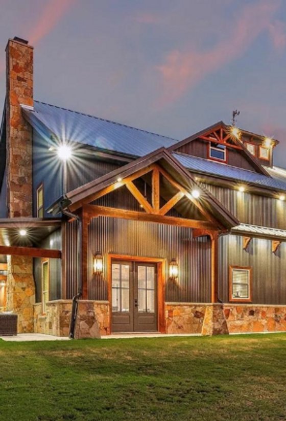 Barndominium with stone and timber front